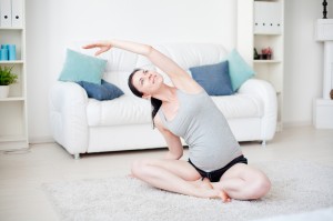 Young pregnant woman do yoga indoors