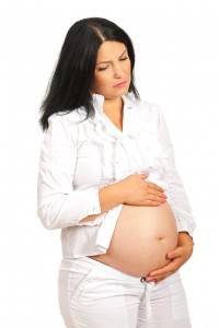 Sad pregnant woman with stomach ache